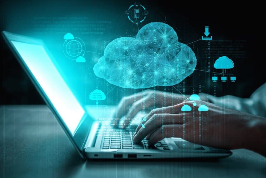 Hands typing on a laptop with a digital cloud and data icons, illustrating cloud computing technology and online data storage for businesses.